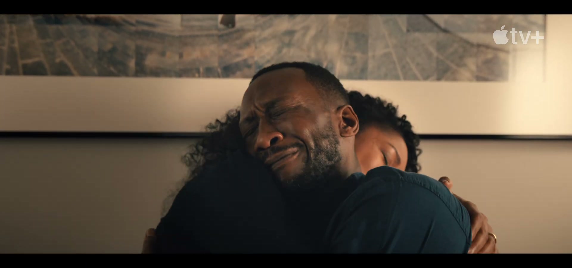Frame from Swan Song featurette — Mahershala Ali and Naomie Harris, with Hayashi's Bodhi Tree panorama on the wall behind them